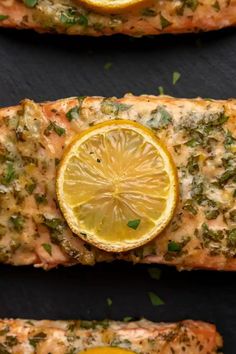 salmon with lemon slices and herbs on top