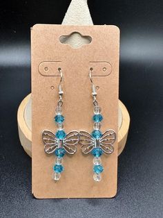 a pair of earrings with blue beads