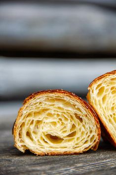 two pieces of bread sitting on top of a wooden table