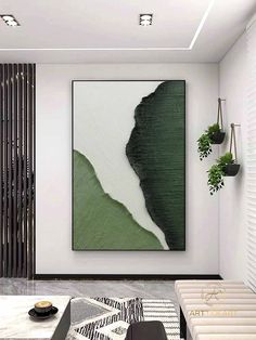 a modern living room with white walls and green art hanging on the wall above it