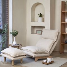 a living room scene with focus on the chaise lounge chair and footstool