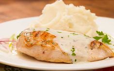 a white plate topped with chicken and mashed potatoes