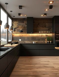 a modern kitchen with wood flooring and black cabinetry is pictured in this image