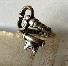 two silver keys are sitting on top of each other