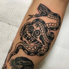 a black and white tattoo with a snake on it