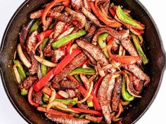 a skillet filled with meat and peppers