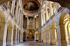 the interior of a church with columns and paintings on the walls, along with marble flooring