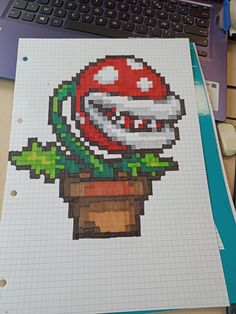 a computer screen with a drawing of a mario mushroom on it's side and a keyboard in the background