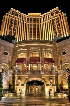 the las vegas hotel and casino is lit up at night, with its lights on