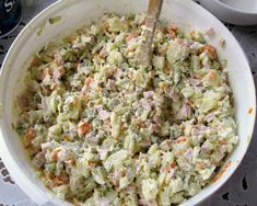 a white bowl filled with food on top of a table