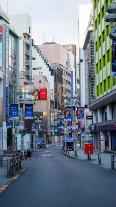 an empty city street with buildings and signs