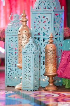 three blue and gold lanterns sitting next to each other