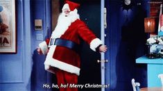 a man dressed as santa claus standing in front of a door