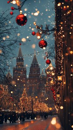 christmas lights are hanging on the side of a building in front of a clock tower