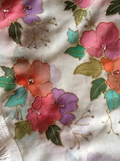 an embroidered fabric with colorful flowers on it