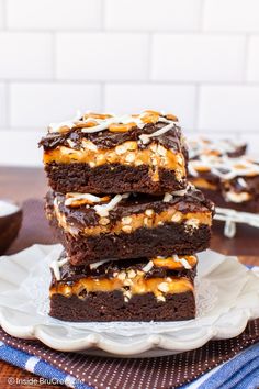 chocolate brownies with caramel drizzled on top stacked on each other