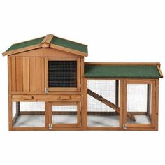 a large wooden chicken coop with green roof