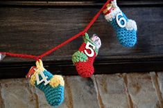 crocheted christmas stockings hanging on a string with the numbers forty and seven attached to them