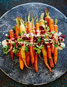 carrots are arranged on a plate with dressing