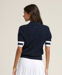 Essex Polo | Wilson Sporting Goods Sporty Fitted Top With Ribbed Neckline, Fitted Golf Tops With Ribbed Collar, Fitted Tops With Ribbed Collar For Golf, Sporty Knit Tops With Ribbed Collar, White Sporty Tops With Ribbed Waistband, Fitted Short Sleeve Tops With Ribbed Cuffs, Classic Navy Sports Top, Navy Classic Sports Top, Sporty Fitted Tennis Tops