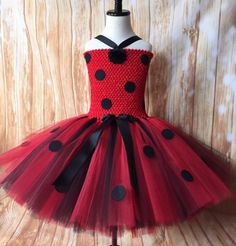 a red and black dress with polka dots on it