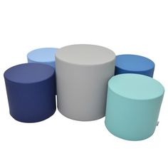 four different colored stools sitting next to each other