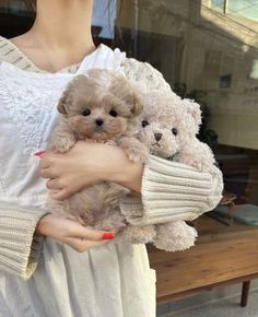 a woman holding two teddy bears in her arms