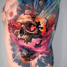 a man's back is covered in tattoos and has an image of a skull on it