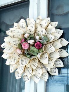 a wreath made out of sheet music and flowers