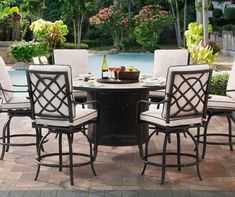 an outdoor dining table with chairs around it