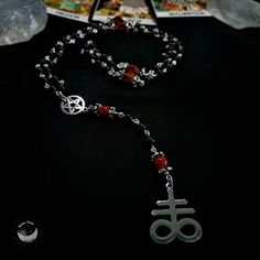 Leviathan Cross Prayer Beads Necklace, Satanic Rosary, Pagan Meditation Beads, Witch's Ladder, Witchy Gift, Witch Rosary, Pagan Jewelry, Amulet, Talisman, Witchy Jewelry, Handmade Jewelry, Handcrafted Necklace. The Satanic Rosary consists of 5 decades of 10 Obsidian Gemstone Beads, and Introduction with 5 beads, Obsidian and Red Agate (55 beads).  Leviathan Prayer Beads Necklace with Black Obsidian, Red Agate Gemstone Beads, White Skulls carved Howlite Beads, Pentacle and Satan Sigil.  Aura of a Witch Rosary, Pagan Meditation, Leviathan Cross, Elements Of Earth, Festival Booth, Psychic Attacks, Energy Protection, Goth Look