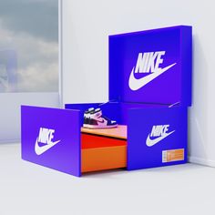 two boxes with nike logos on them sitting next to each other