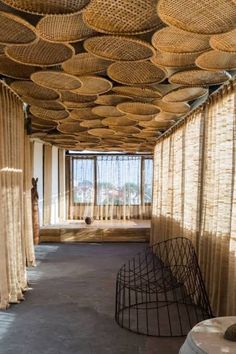 an empty room with lots of wicker covering the ceiling