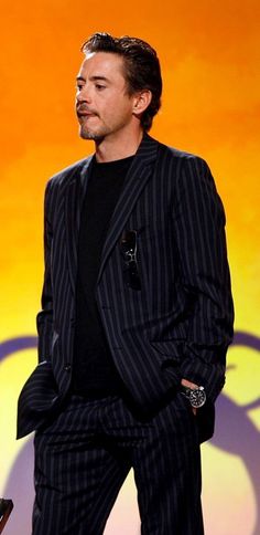 a man in a pinstripe suit standing on stage