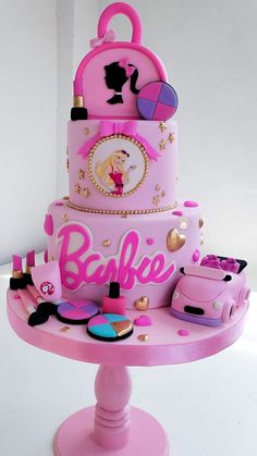 there is a pink cake with barbie on it