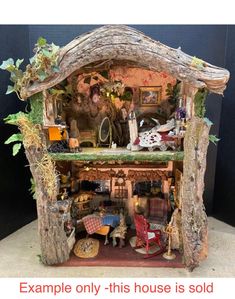 a doll house made out of wood with furniture and decorations on the top floor, in front of a black background