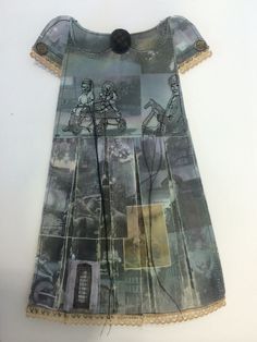 a dress made out of old clothes with pictures on the front and back, sitting on a white surface