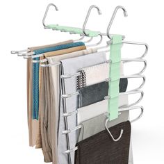 an over - the - door drying rack holds several folded clothes