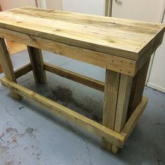 a wooden table sitting in the middle of a room