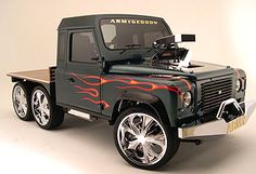 a toy truck with flames painted on it's sides and wheels, sitting in front of a white background