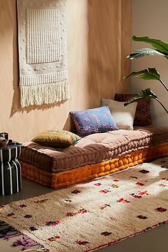 a living room filled with lots of furniture and decor on top of a carpeted floor