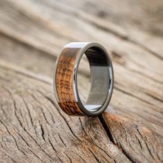 a wedding ring with wood inlays on it