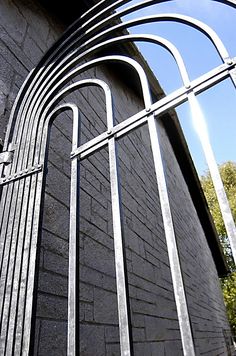 an iron gate is on the side of a building