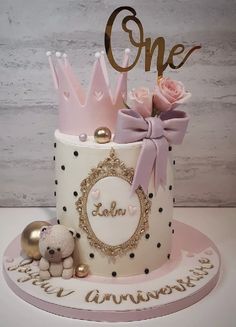 a birthday cake decorated with pink and gold decorations