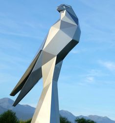 a large bird statue sitting on top of a wooden table