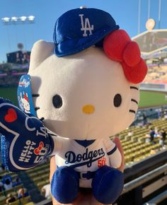 a hello kitty stuffed animal in a dodgers baseball uniform