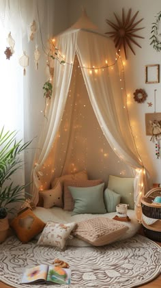 a room with a bed covered in white curtains and lights