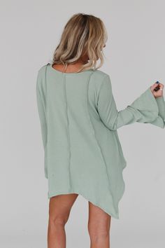 Step into the enchanting Golden Hour Long Bell Sleeve Top and embrace the boho vibes! Whether you're strolling through a festival or enjoying a casual day out, this top will add a touch of bohemian magic to your outfit because it features: Comfortable mini ribbed knit fabric Relaxed and loose silhouette for effortless style Flattering v - neckline Loose long bell sleeves for a whimsical look Exposed seams throughout create a unique boho aesthetic Cute uneven bottom edge detail adds an extra touc Spring V-neck Tunic For Loungewear, Free-spirited Cotton Top For Spring, Green V-neck Tunic For Fall, Bohemian Relaxed Fit Top For Loungewear, Bohemian Loungewear Top With Relaxed Fit, Bohemian Cotton Tops For Loungewear, Free-spirited Cotton Tops For Fall, Relaxed Fit Tunic For Spring Day Out, Fall Cotton Free-spirited Tops