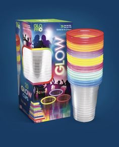 a stack of plastic cups sitting in front of a box with its lid open and the packaging on it