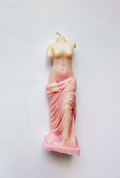 a pink and white statue of a woman